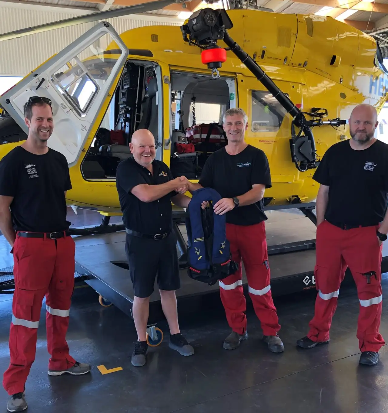 Neil from MTF Finance Gisborne donating a set of  life vests to Eastland Helicopter Rescue Trust
