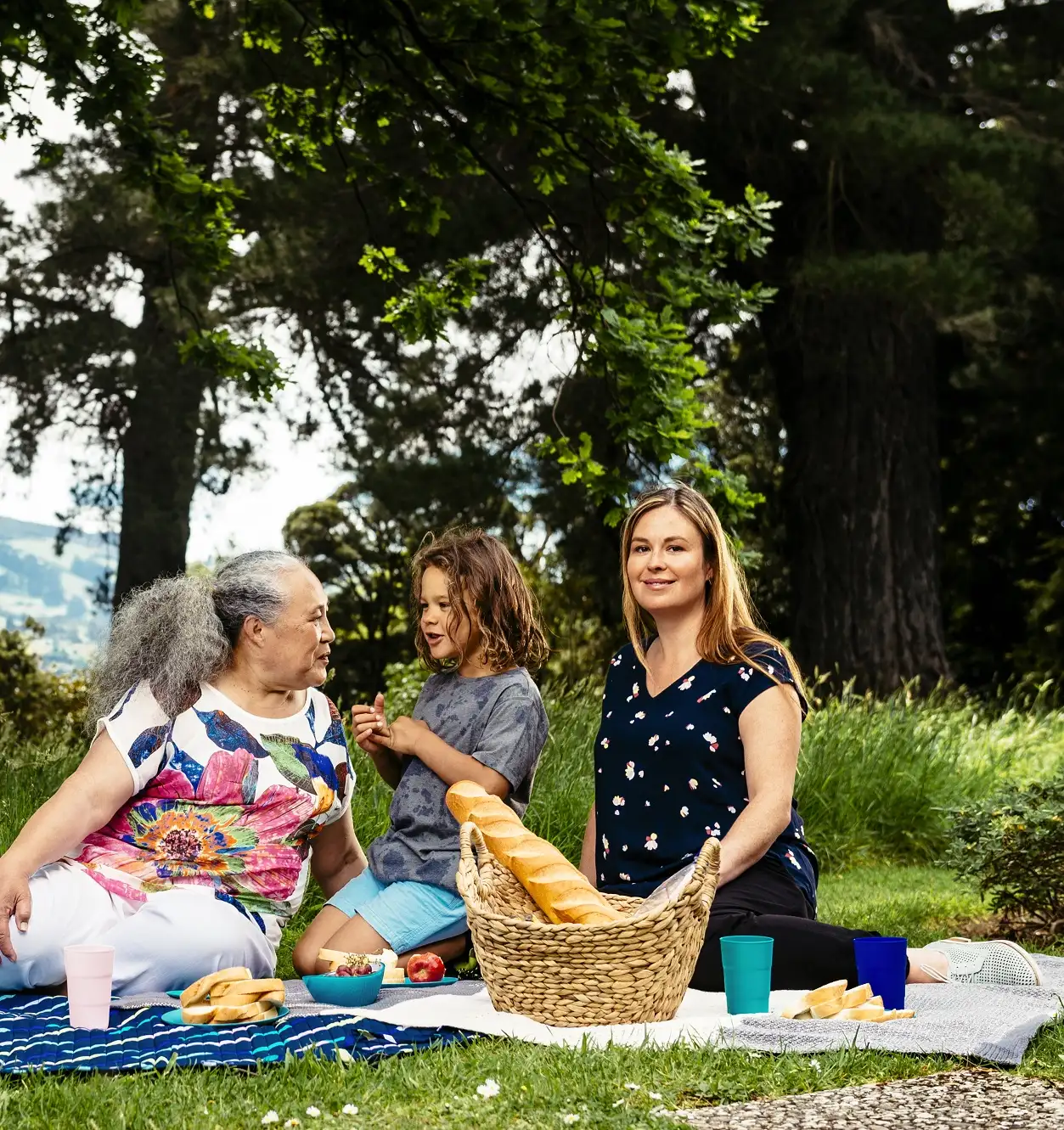 Grandmother, grandson and daughter having a picnic