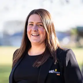 Woman posing for headshot with grass in foreground