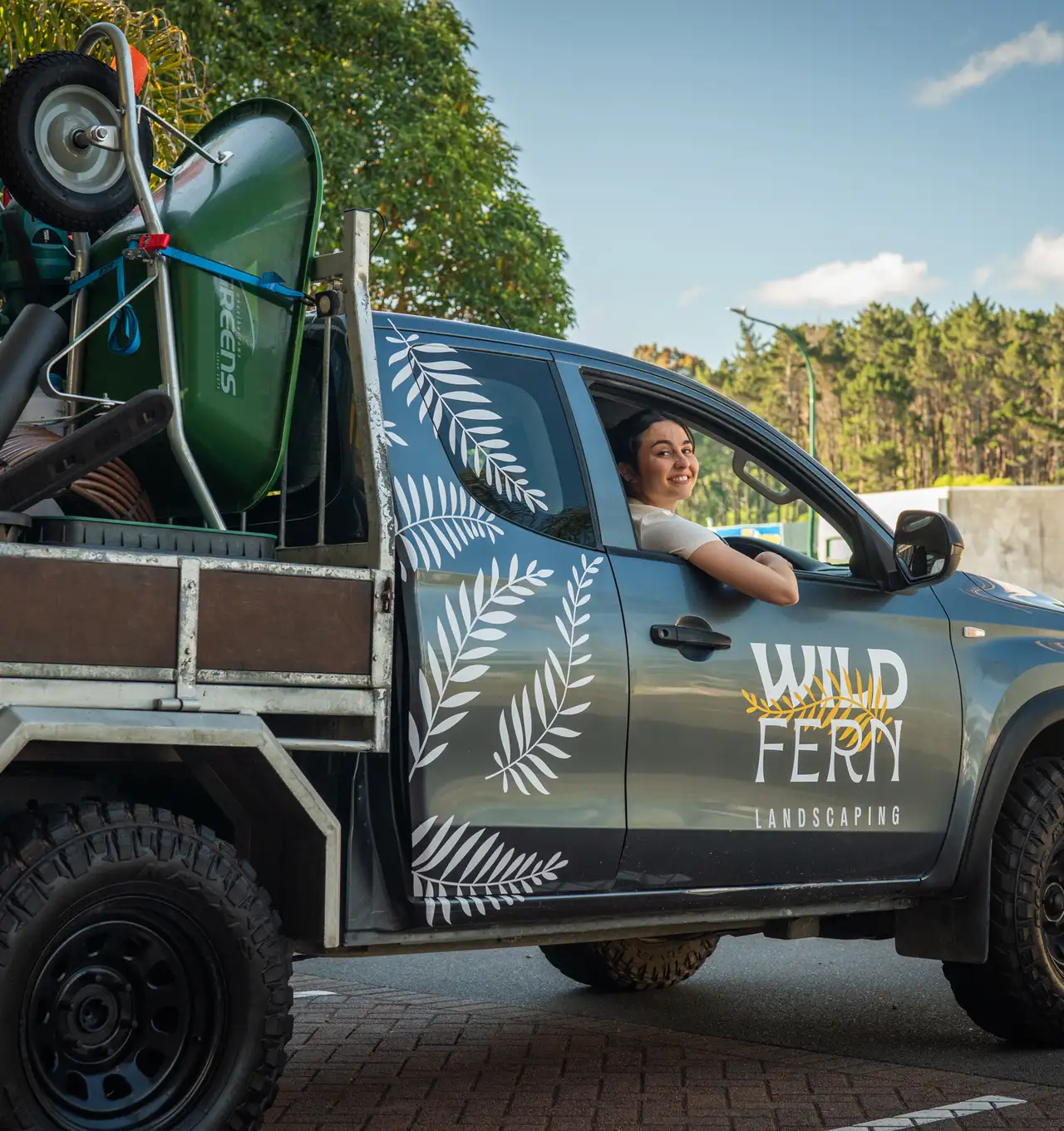 A business owner happy about her new work truck and tools