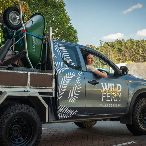 A business owner happy about her new work truck and tools