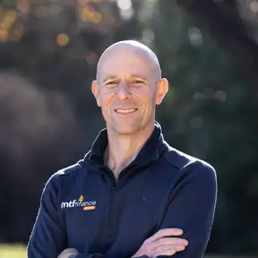 Man with arms crossed posing for a headshot