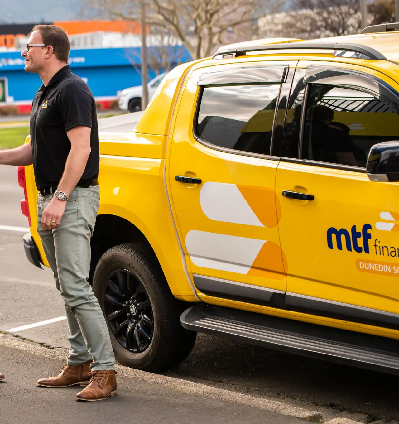 An MTF Finance team member greeting two people