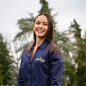 Woman standing in a field posing for a headshot