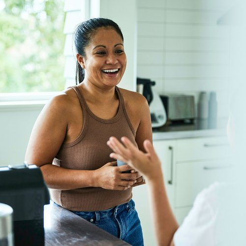 Woman talking to a friend in her kitchen