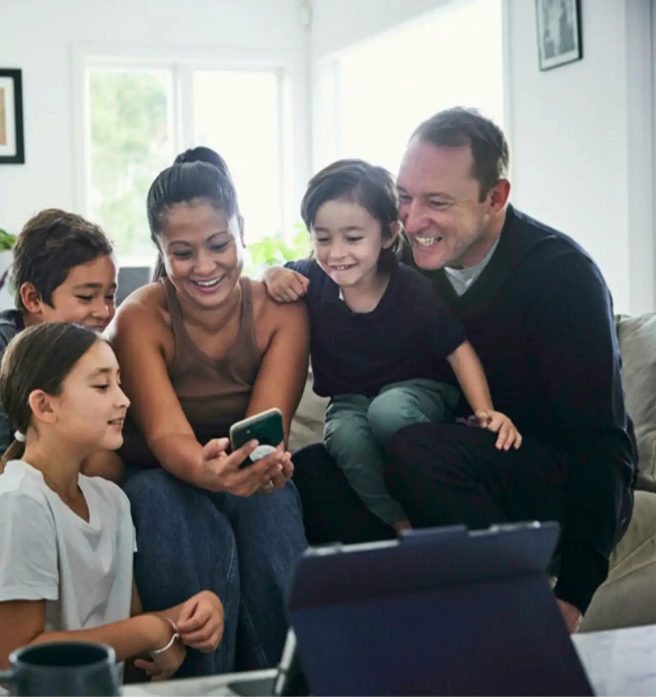 Happy family looking at a smartphone